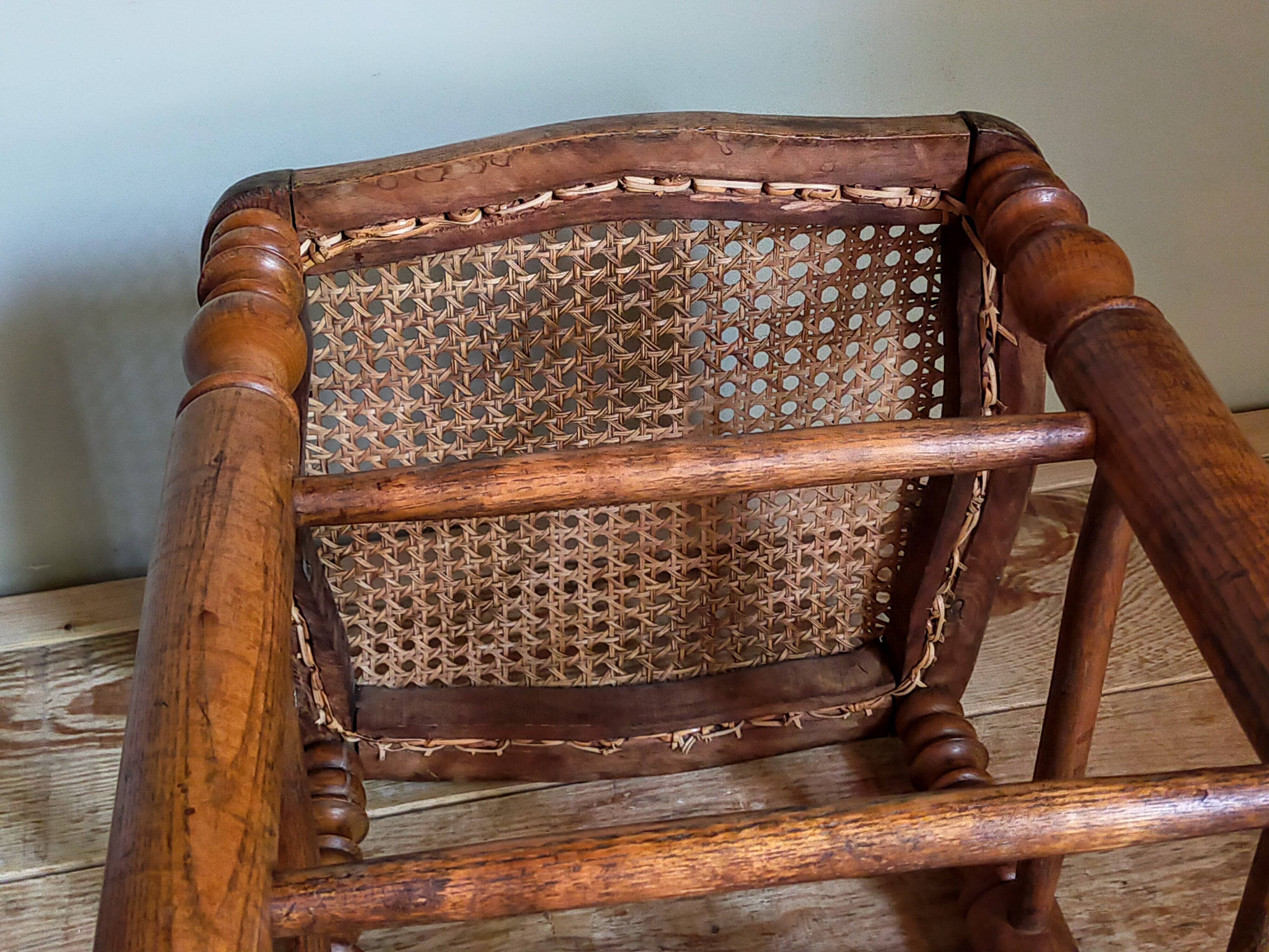 Antique stool with cane and turned wood