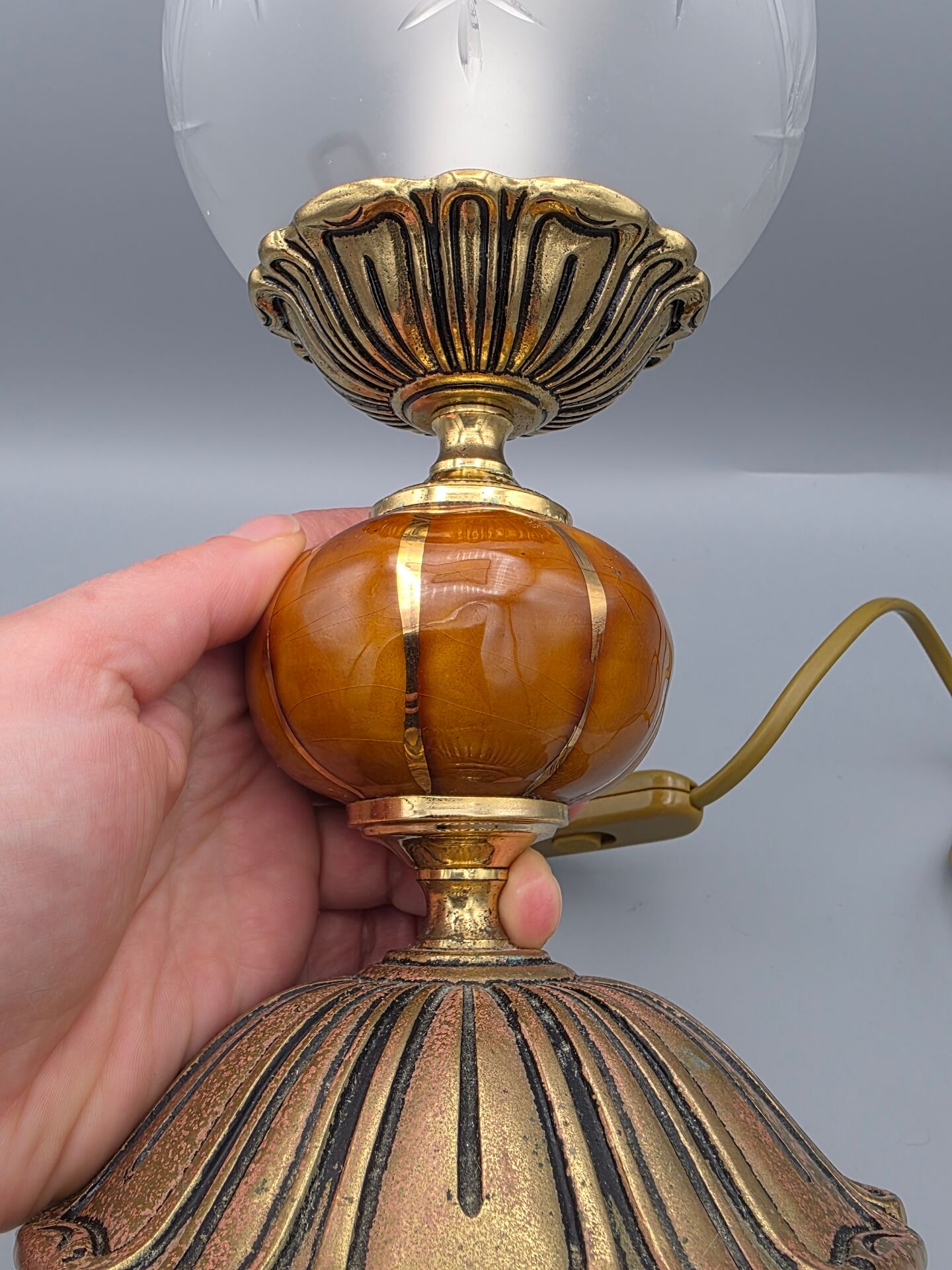 Hollywood Regency bedside lamp in gold metal with a glass globe.