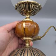Hollywood Regency bedside lamp in gold metal with a glass globe.