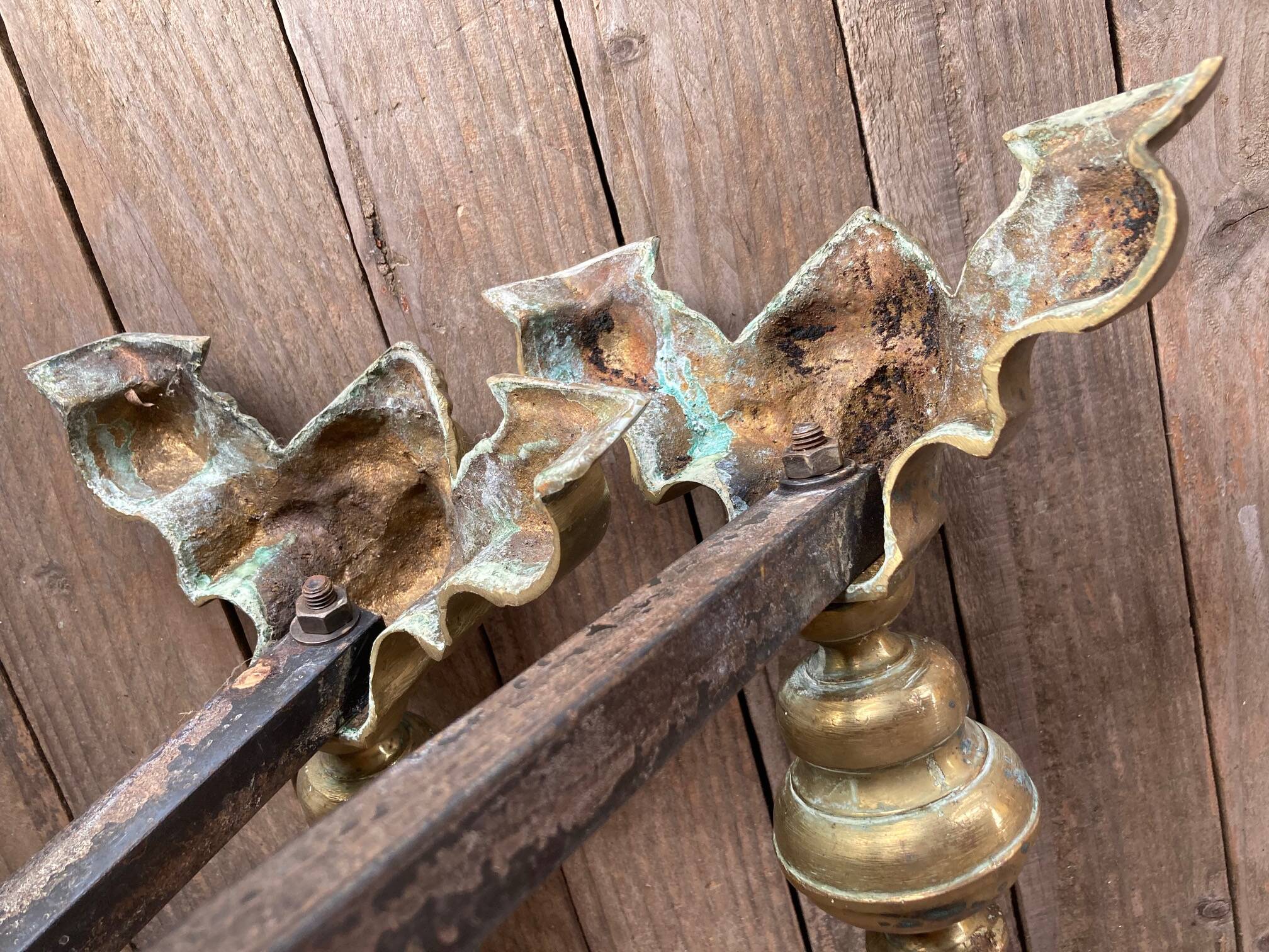 Pair of andirons and grates in cast iron and bronze with gilded grotesques, 17th century