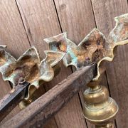 Pair of andirons and grates in cast iron and bronze with gilded grotesques, 17th century