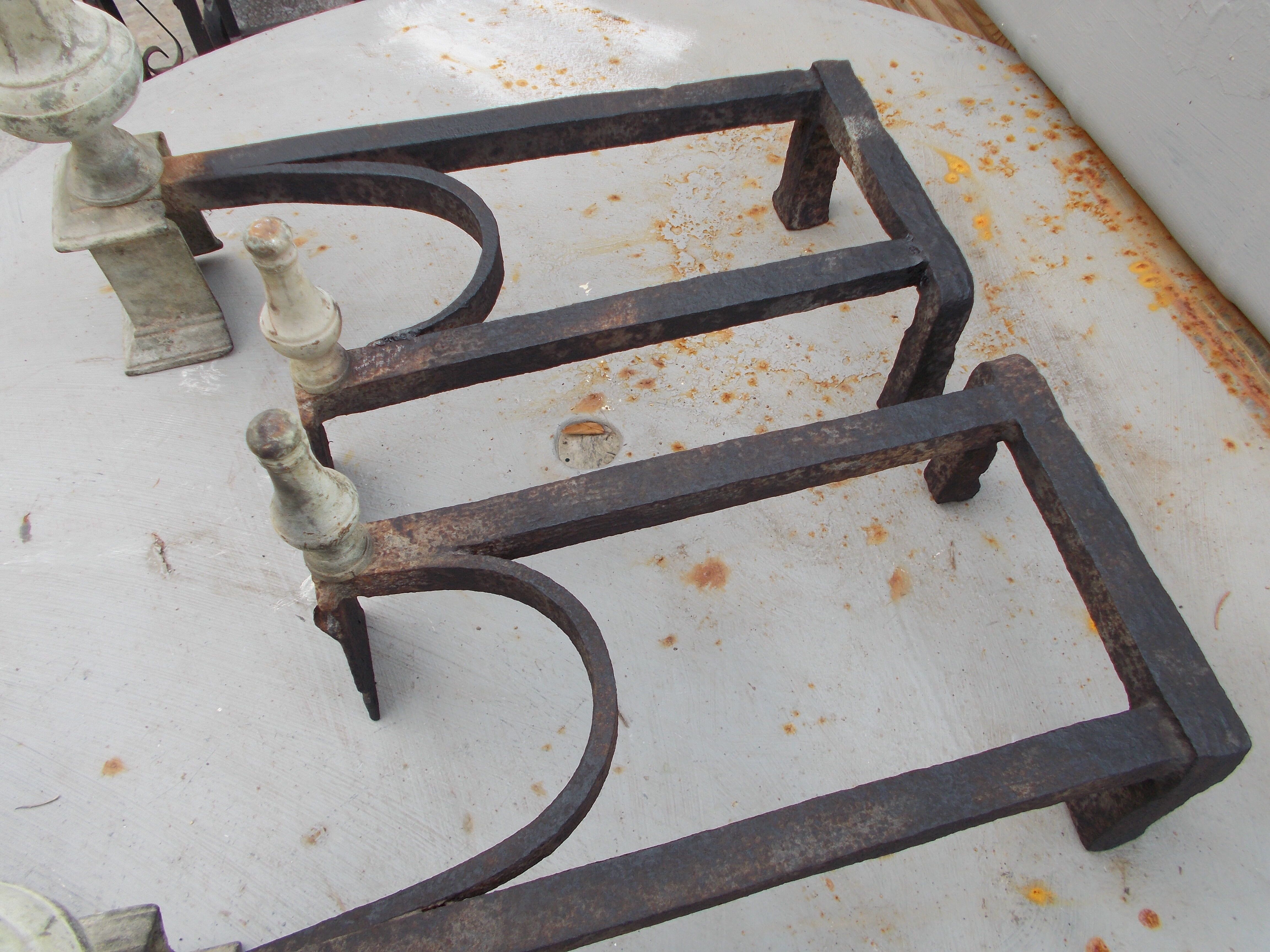 Old pair of wrought iron and bronze pegs