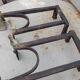 Old pair of wrought iron and bronze pegs
