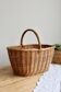 Large vintage woven wicker basket with a central handle.