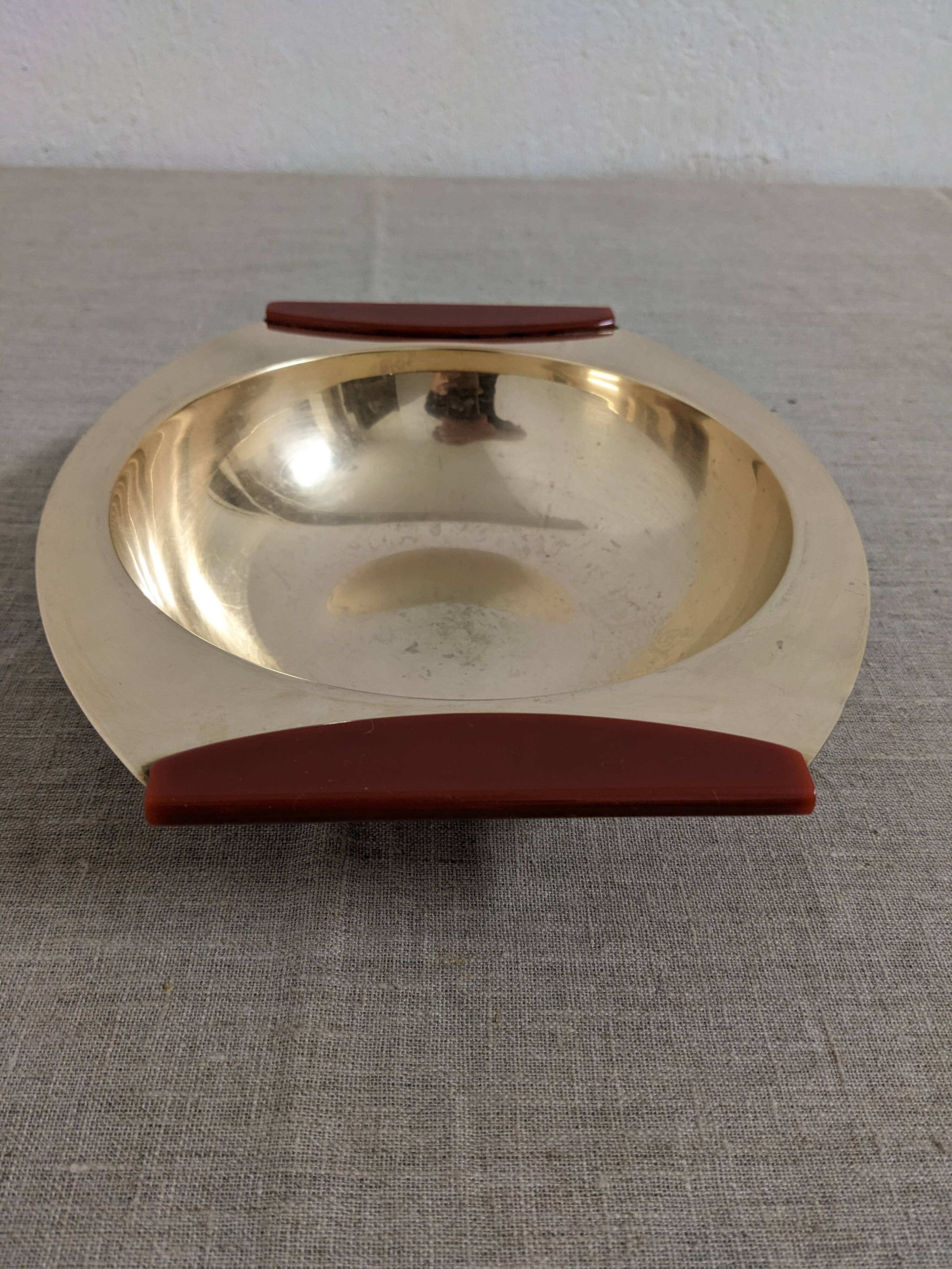 Plates and a brass and Bakelite cut by PM Italy, Italy around 1970.