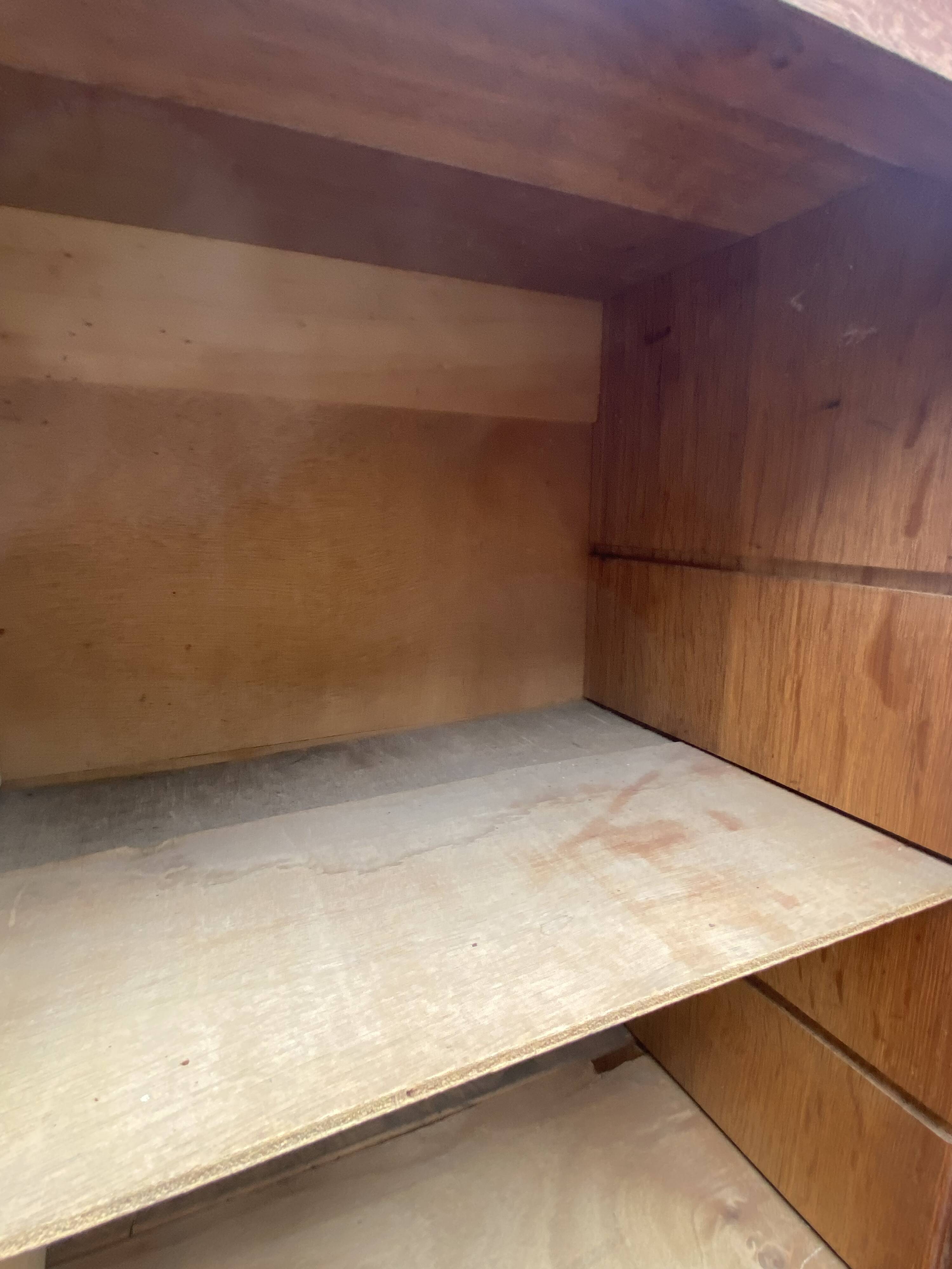 Oak two-column filing cabinet with curtains.