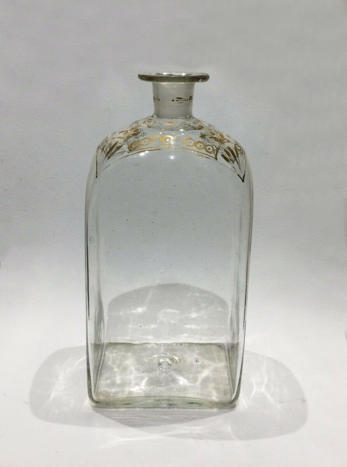 Glass bottle decorated with gold motifs