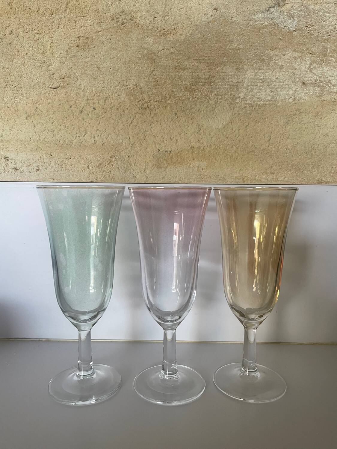 3 iridescent colored champagne glasses