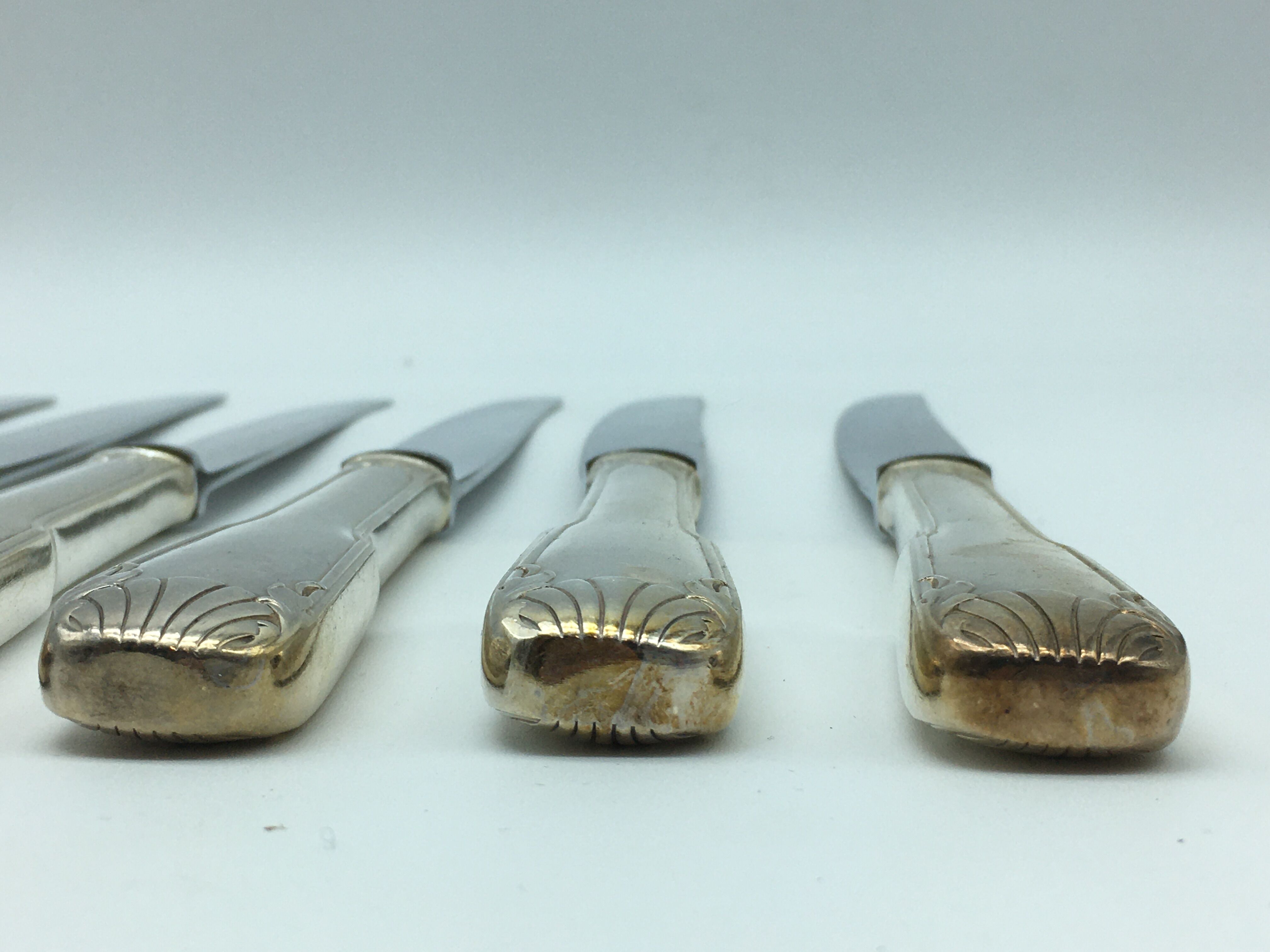 12 silver metal knives.