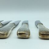 12 silver metal knives.