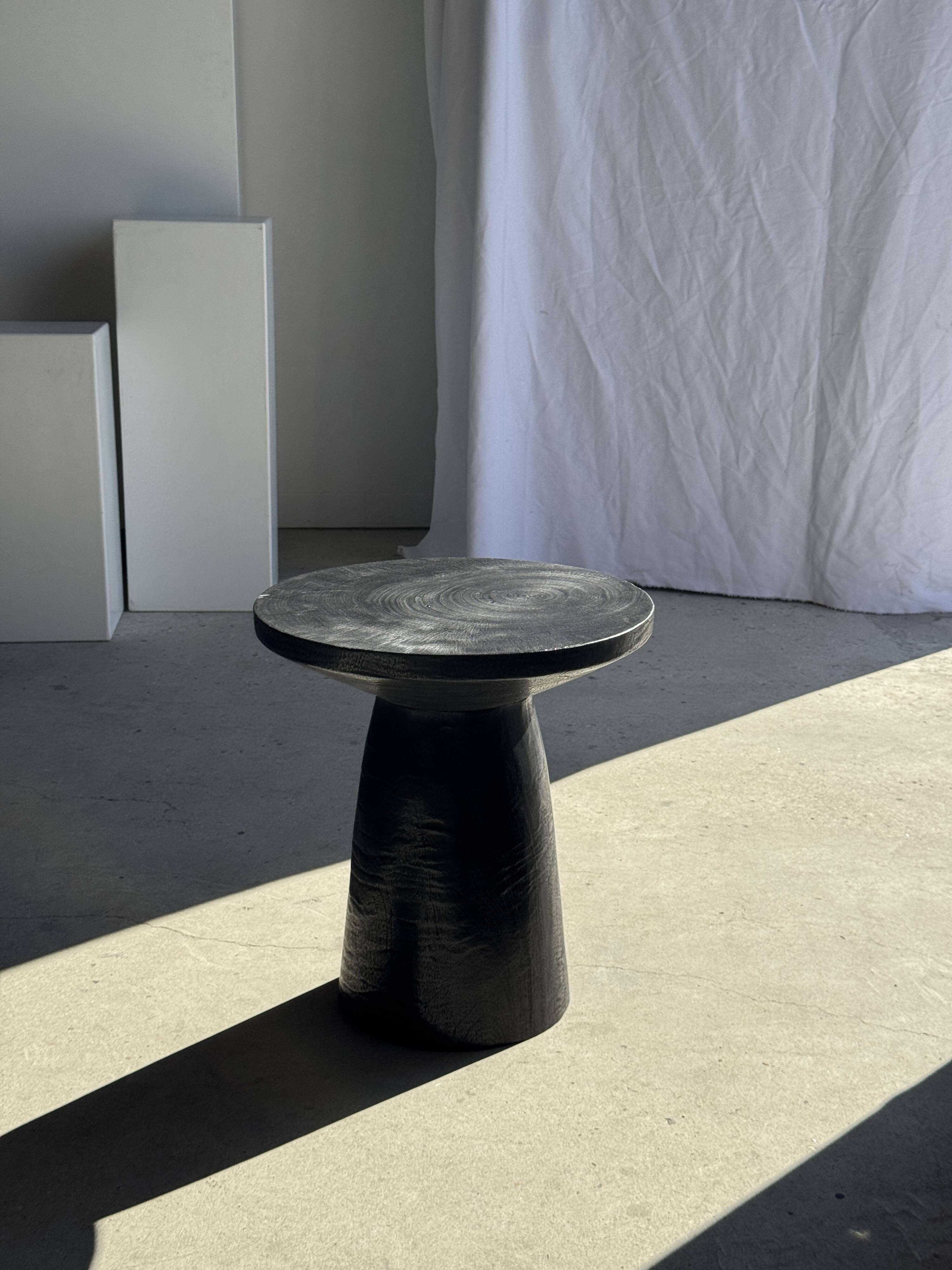 Black solid mango side table (monoxyle) with conical legs