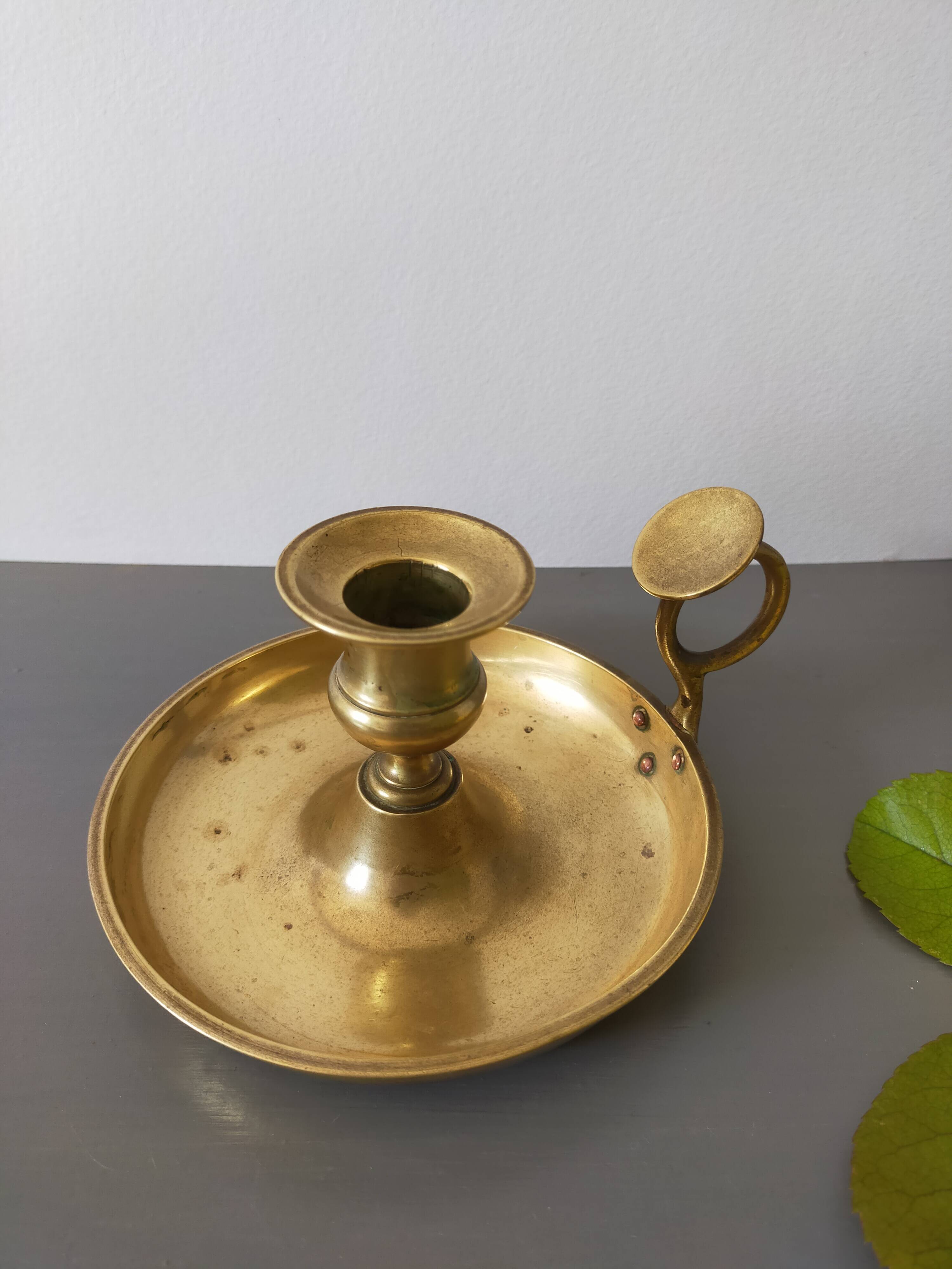 brass candle holder with old cellar rat thumb