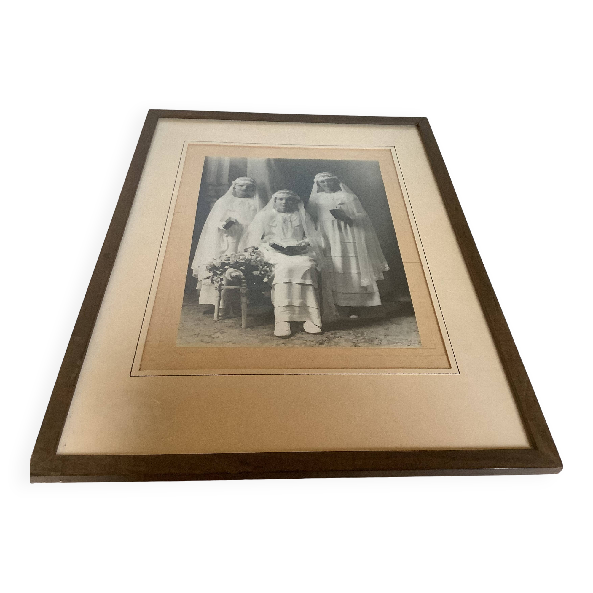 Large frame old photograph of a trio of communicants.