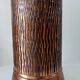 Vintage brutalist umbrella stand in hammered copper with a wood effect.