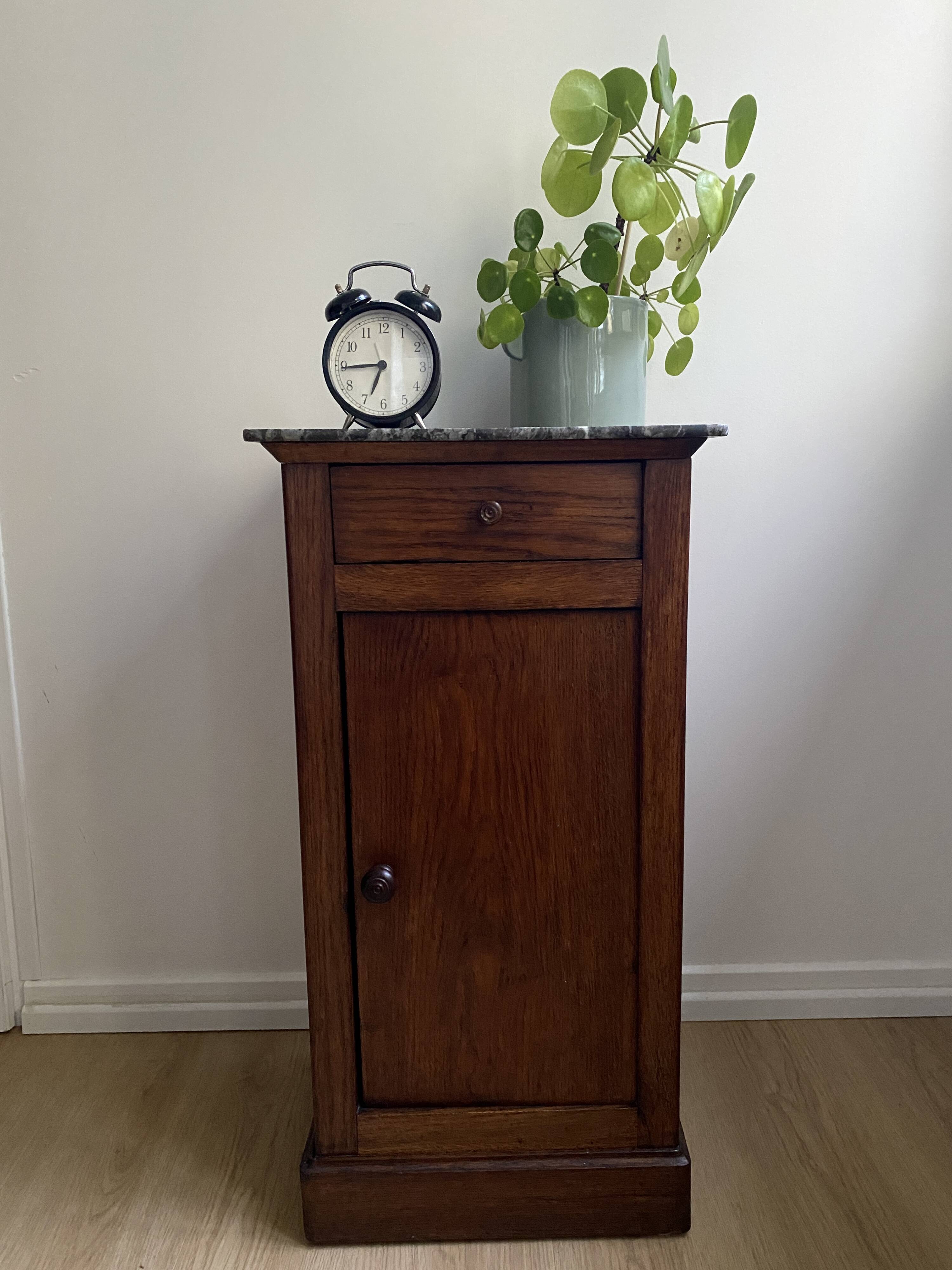 Vintage bedside table in the shape of a wooden column and a gray marble top
