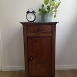 Vintage bedside table in the shape of a wooden column and a gray marble top