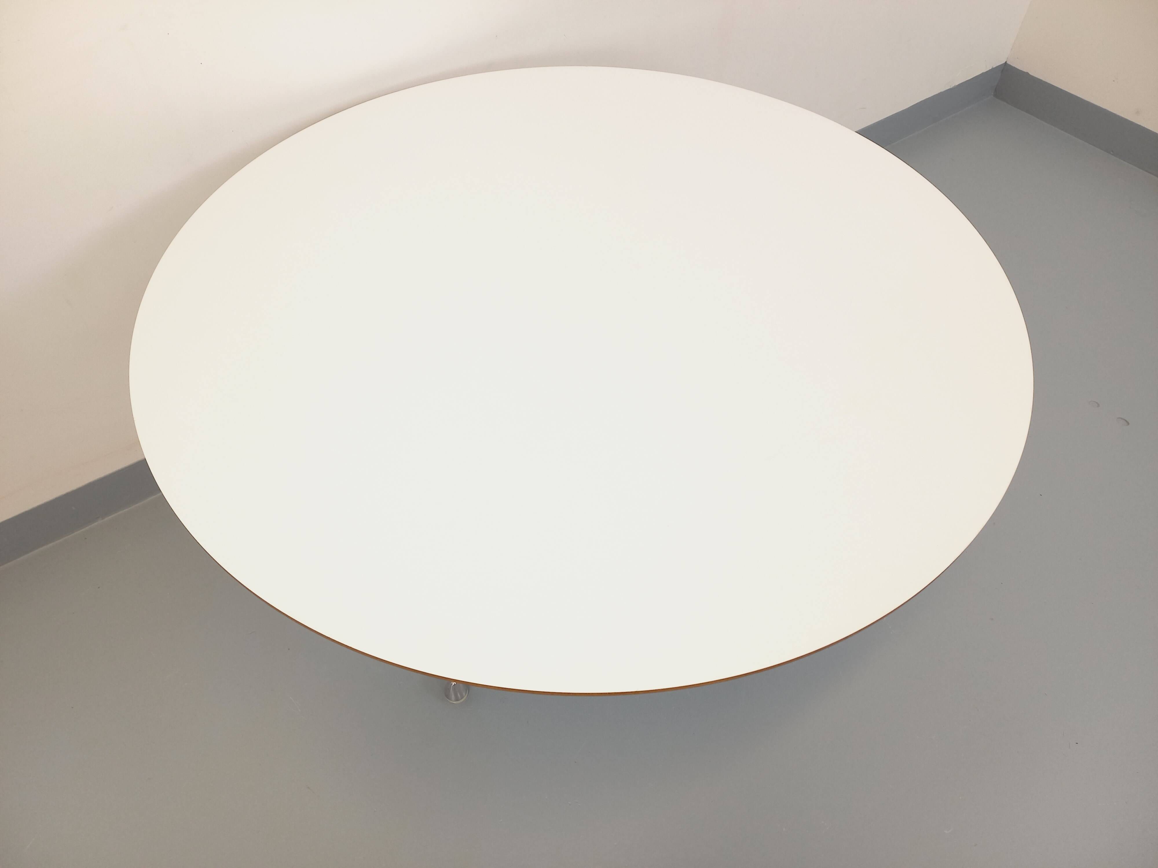 Vintage Eames round table for Vitra in white melamine, wood, and metal.