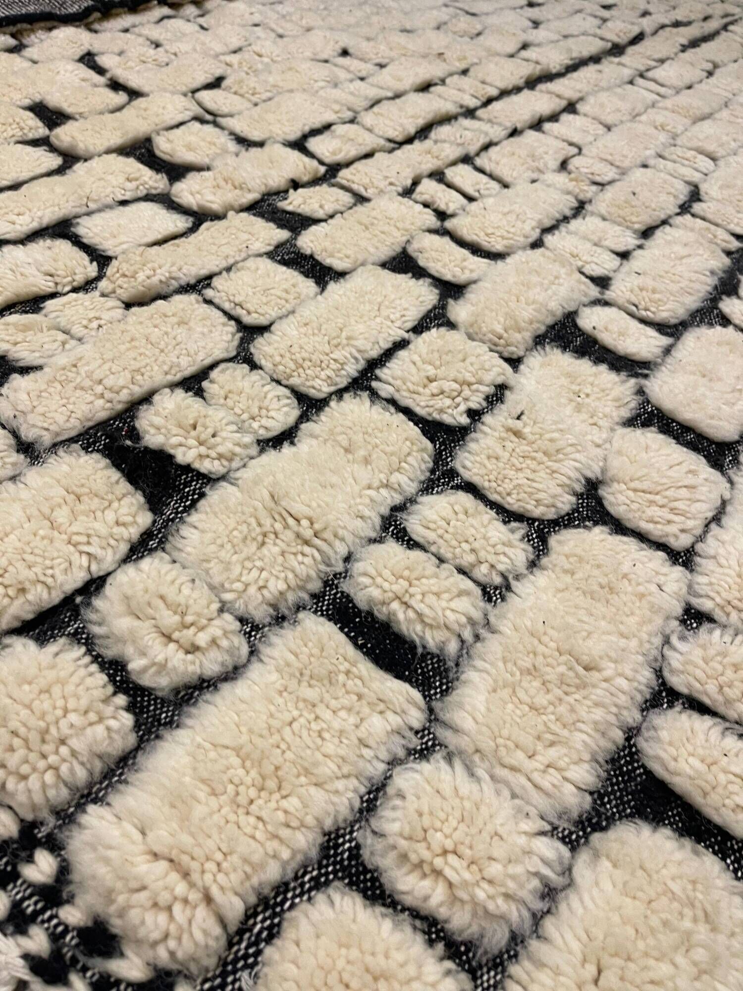 Large cream and black checked Berber rug, 280 × 200 cm.