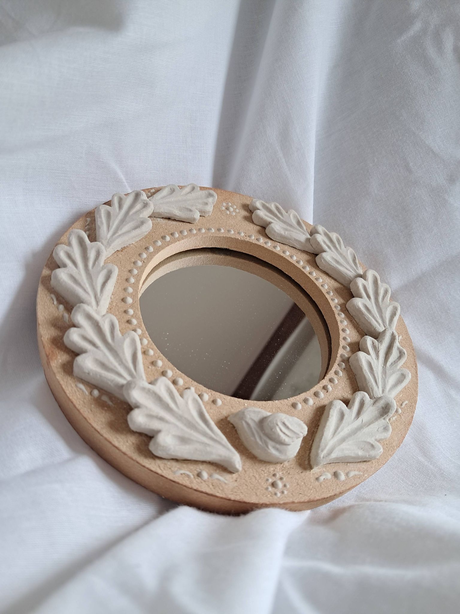Red and white stoneware mirror, oak leaves