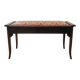 Antique wooden storage bench with red fabric.