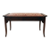 Antique wooden storage bench with red fabric.