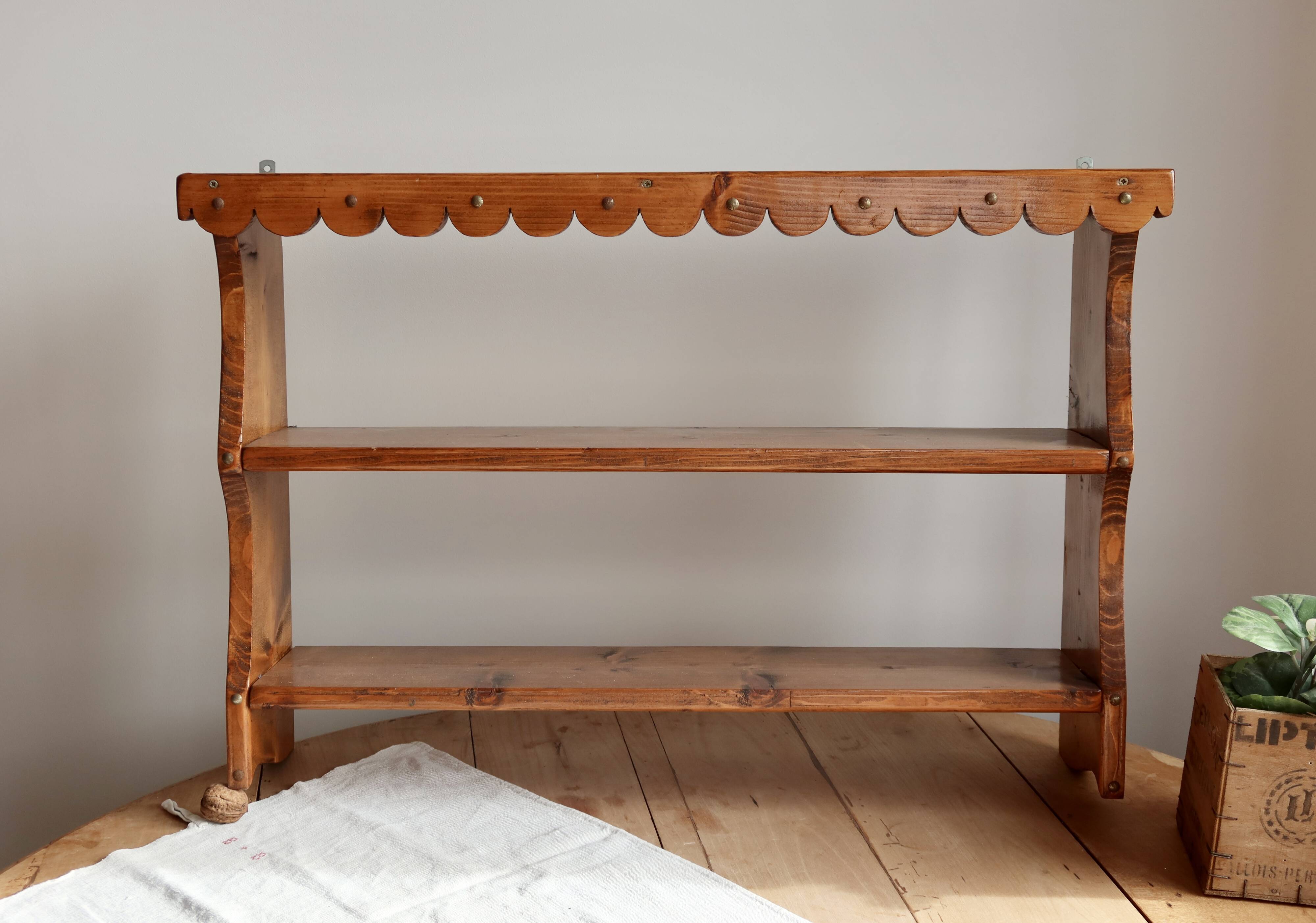 Vintage pine wall shelf with a scalloped front.