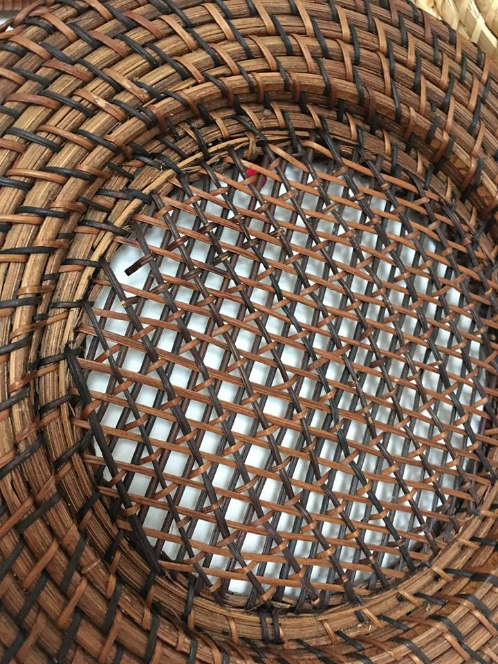 Wall composition of seven baskets and wicker trays.
