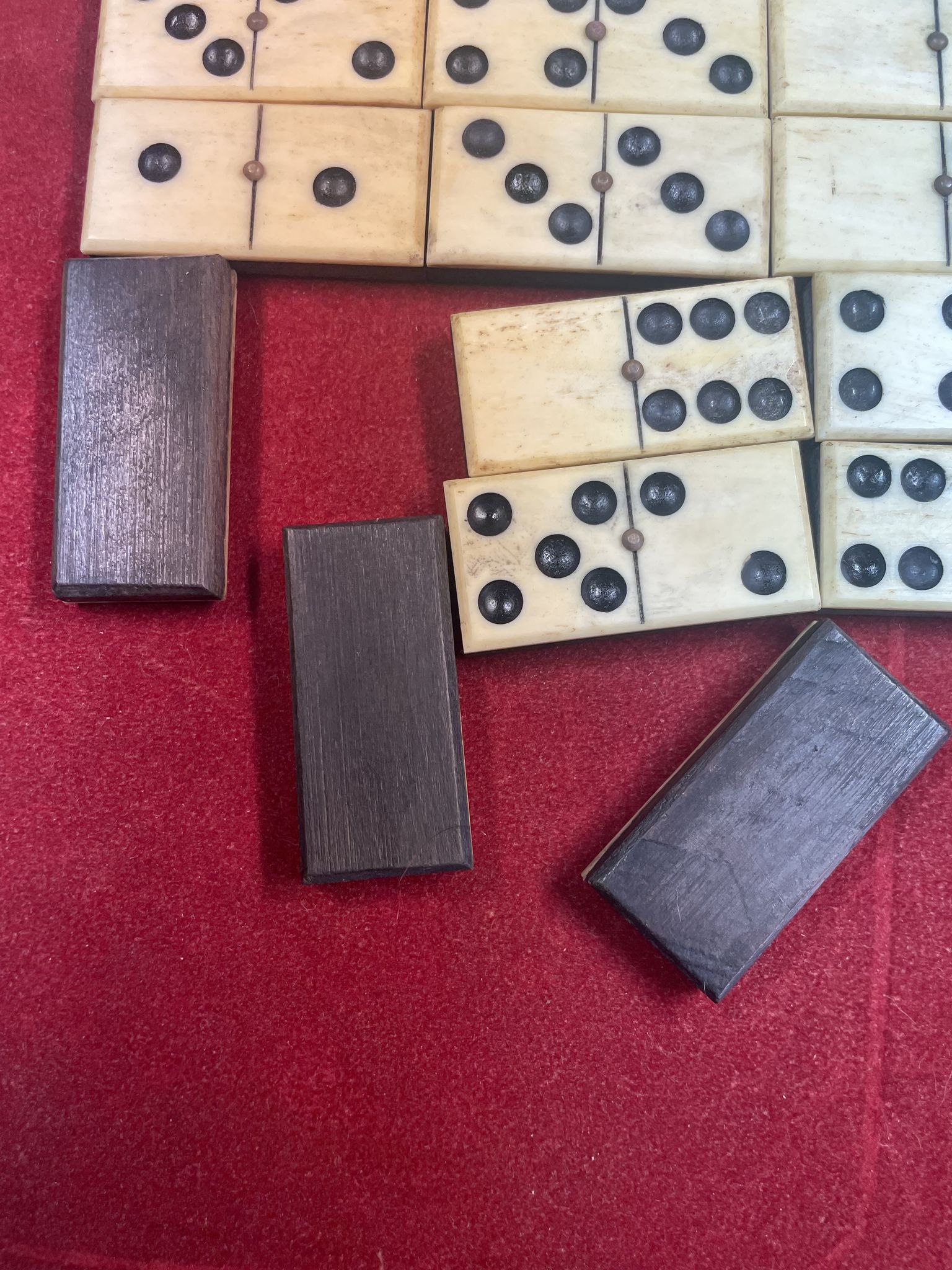 Set of complete dominoes made of bone, nails and blackened wood