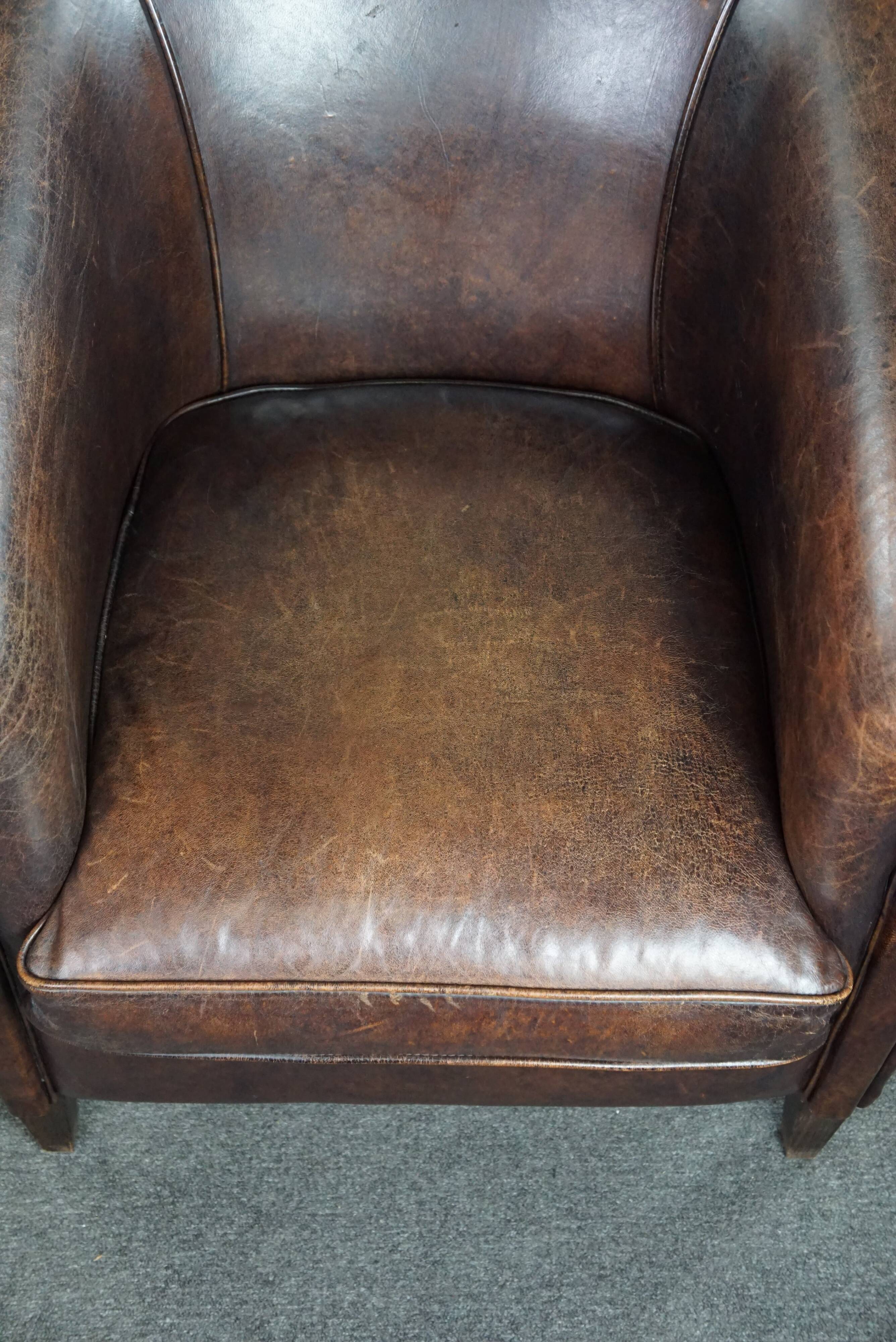 Dark sheep leather club armchair, sleek design