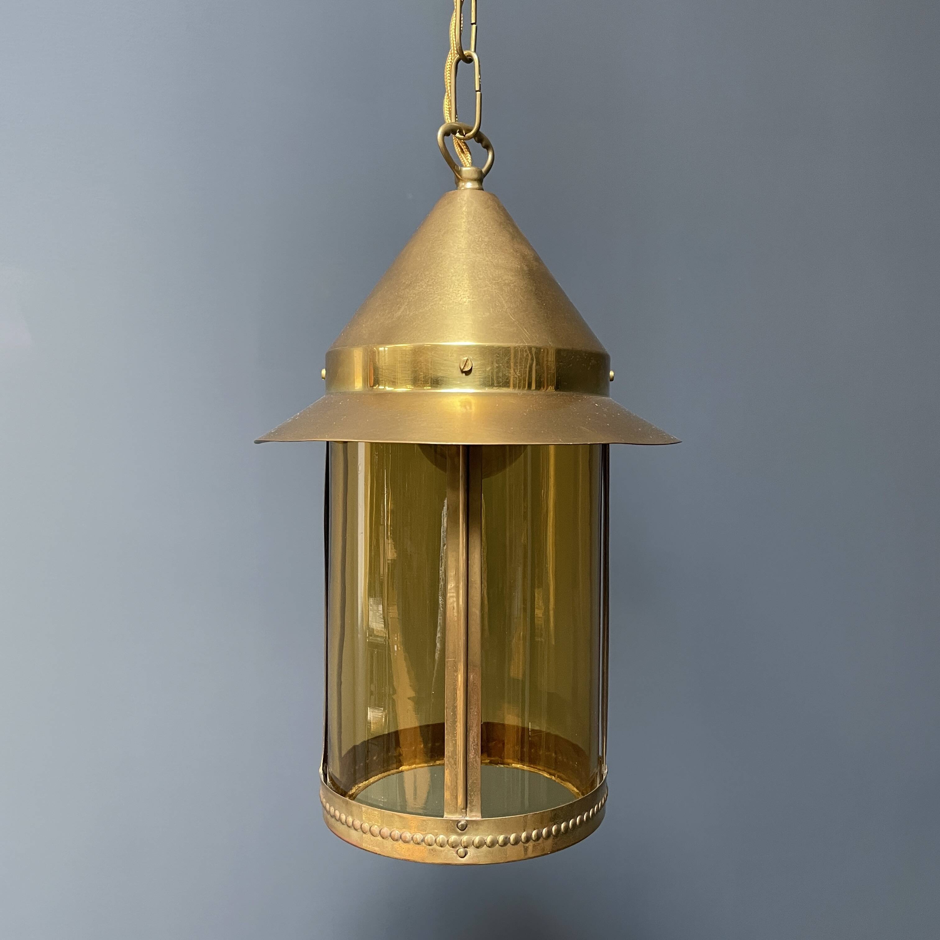 Brass lantern pendant lamp with yellow glass