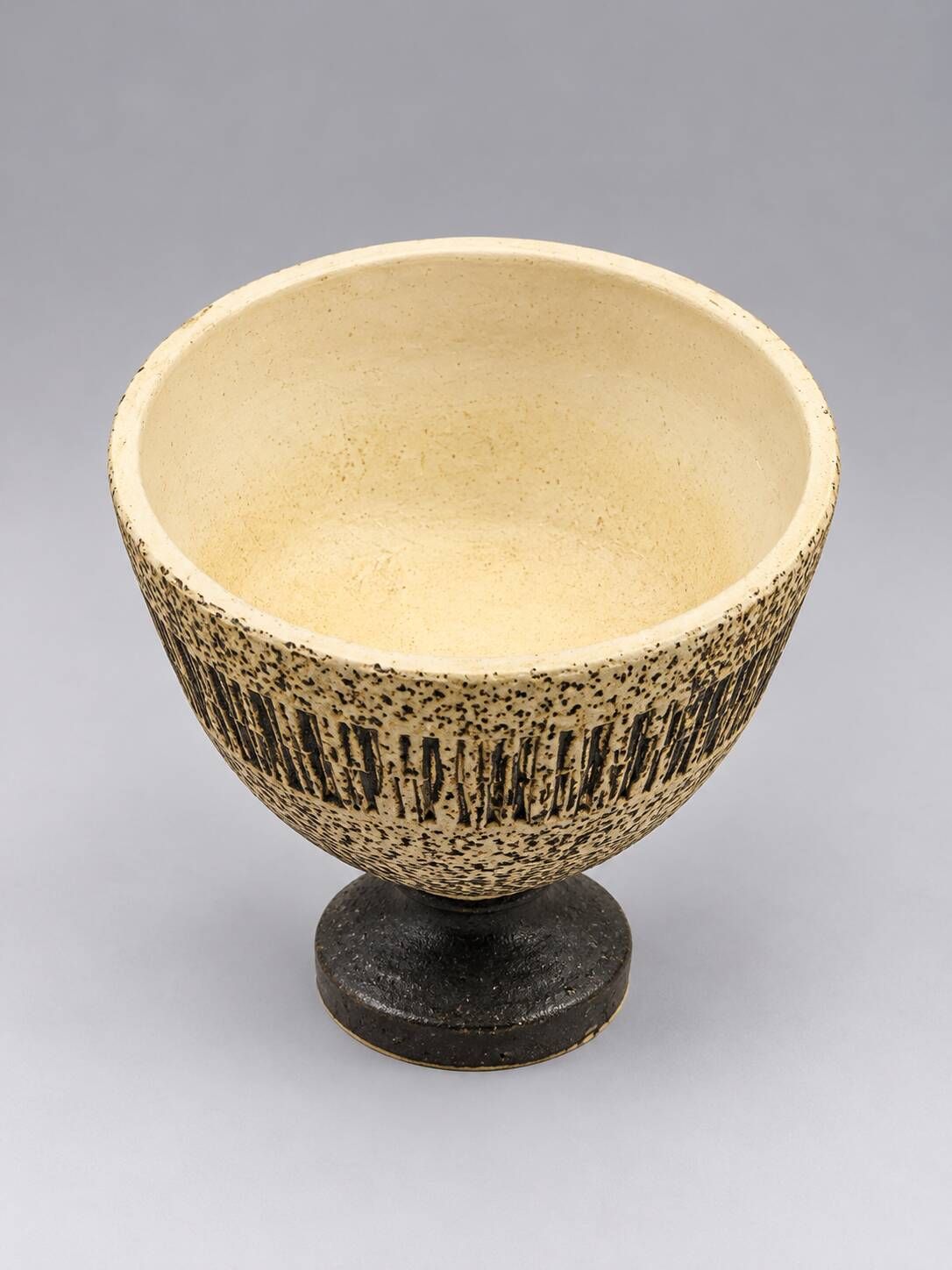 Vintage ceramic pedestal bowl – textured black and beige decor
