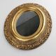 French Baroque style oval mirror in gilded wood with floral decorations