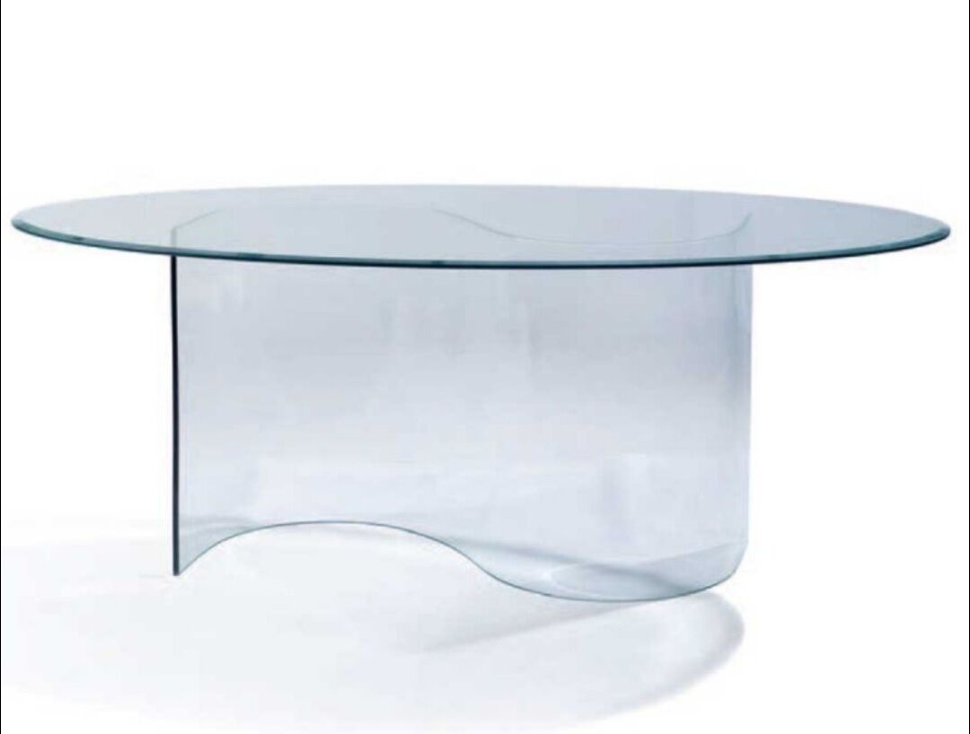 Large glass table with a curved leg.