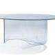 Large glass table with a curved leg.