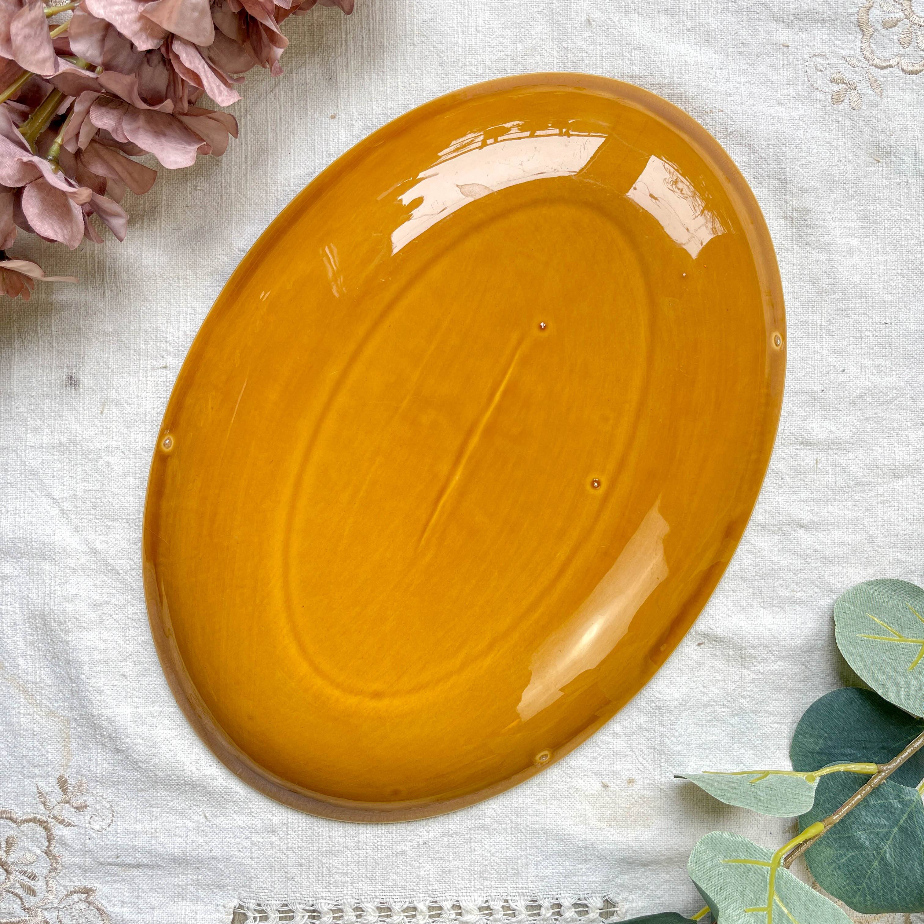 Vintage oval dish in ochre French earthenware from the 70s