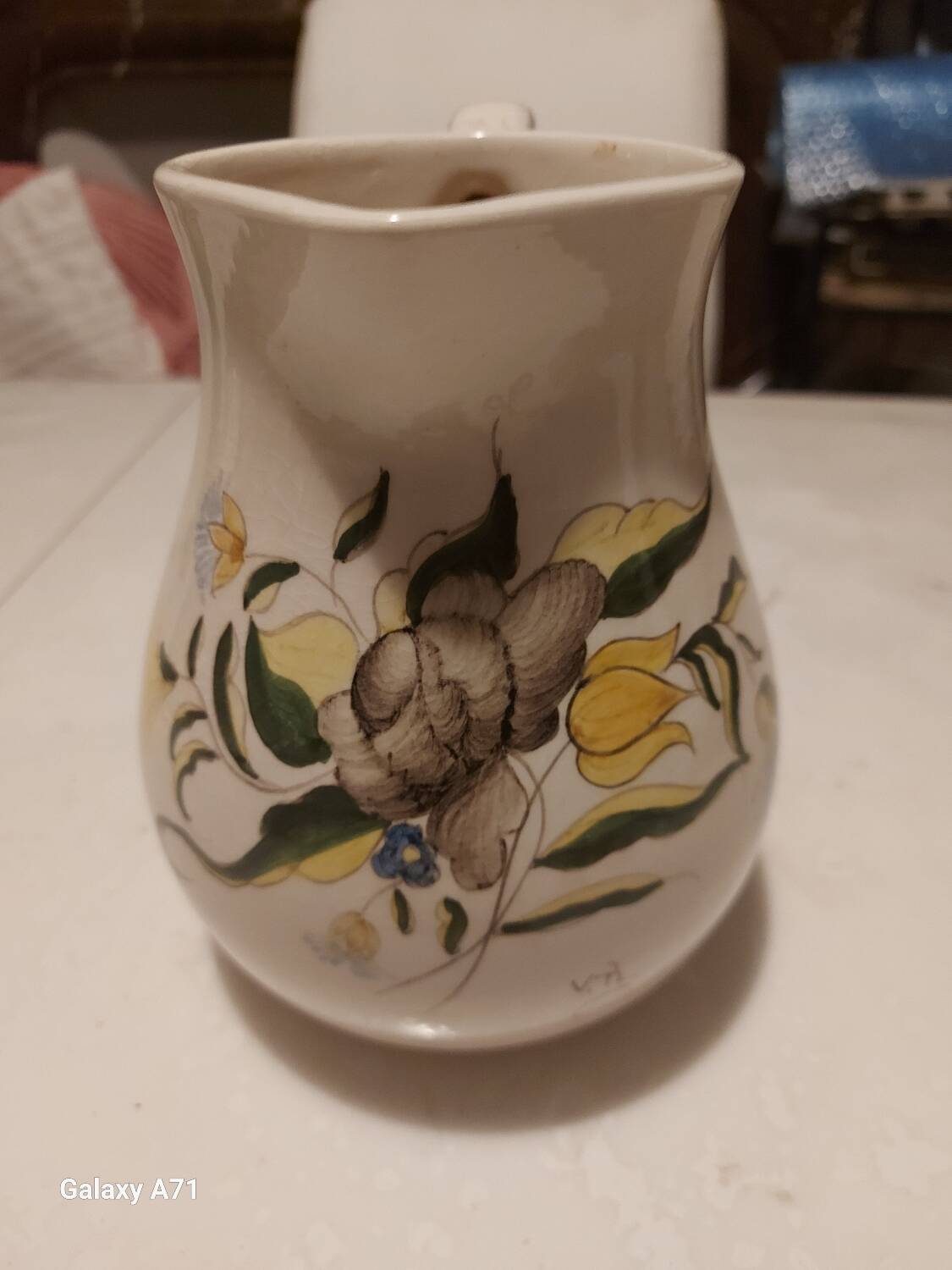 Earthenware pitcher with floral motifs in the Moustiers style, signed.