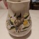 Earthenware pitcher with floral motifs in the Moustiers style, signed.