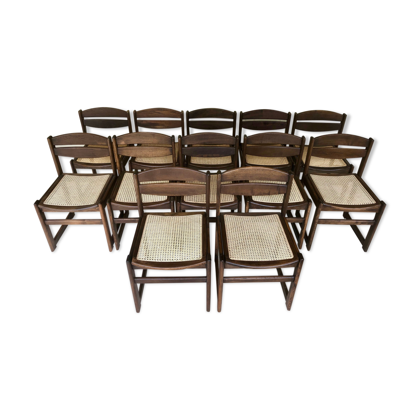 Set of 12 "sledge" dining chairs in walnut and cane.