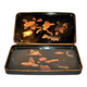 Set of two brown and black Chinese lacquer trays with bird decor