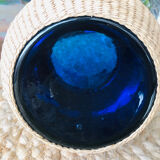 Blue blown glass vase and basketry