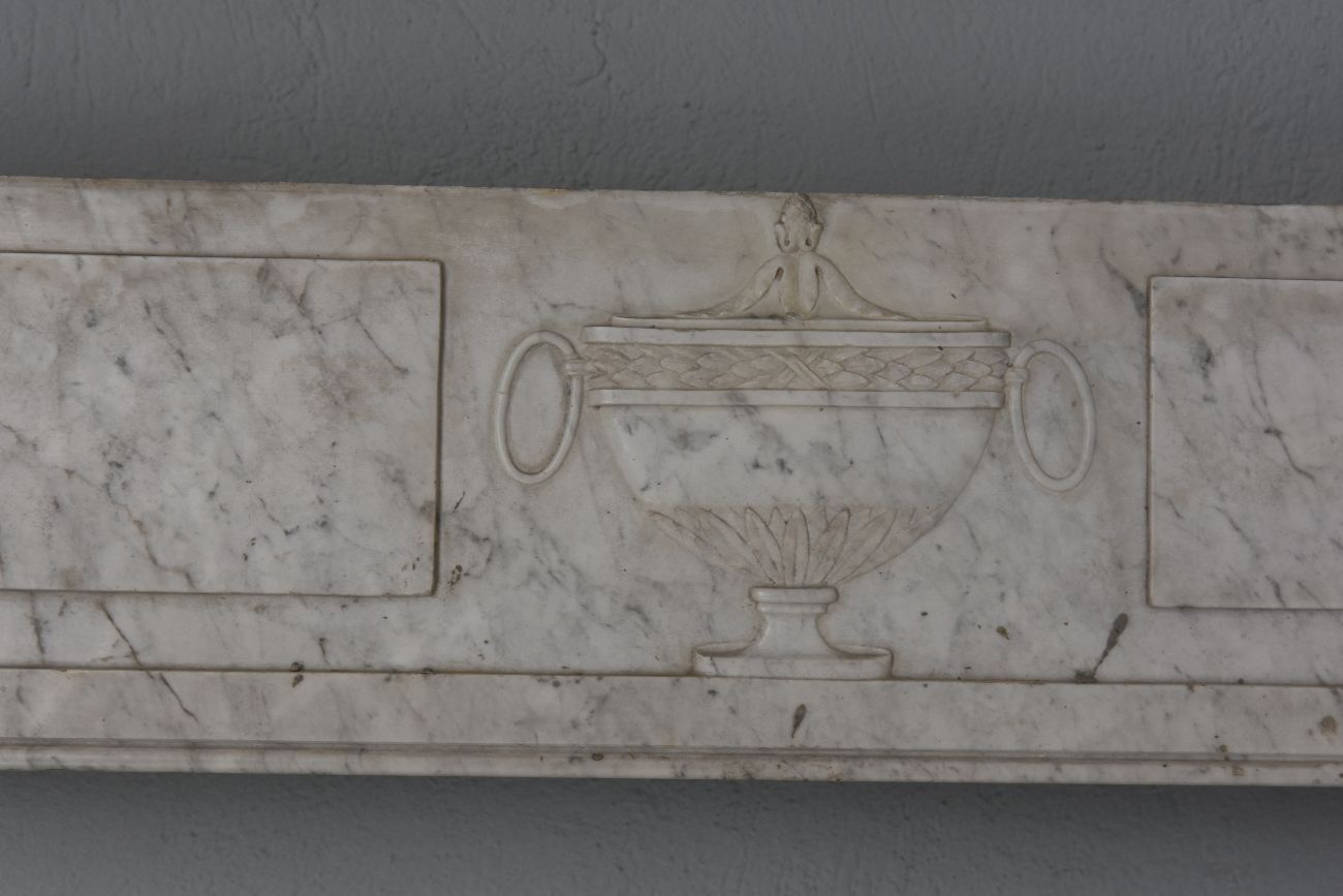 Old fireplace in white marble veined Louis XVI