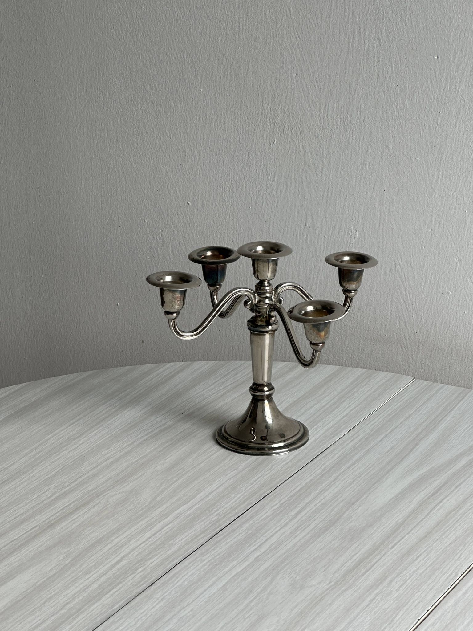 Candlestick candle holder in patinated silver metal