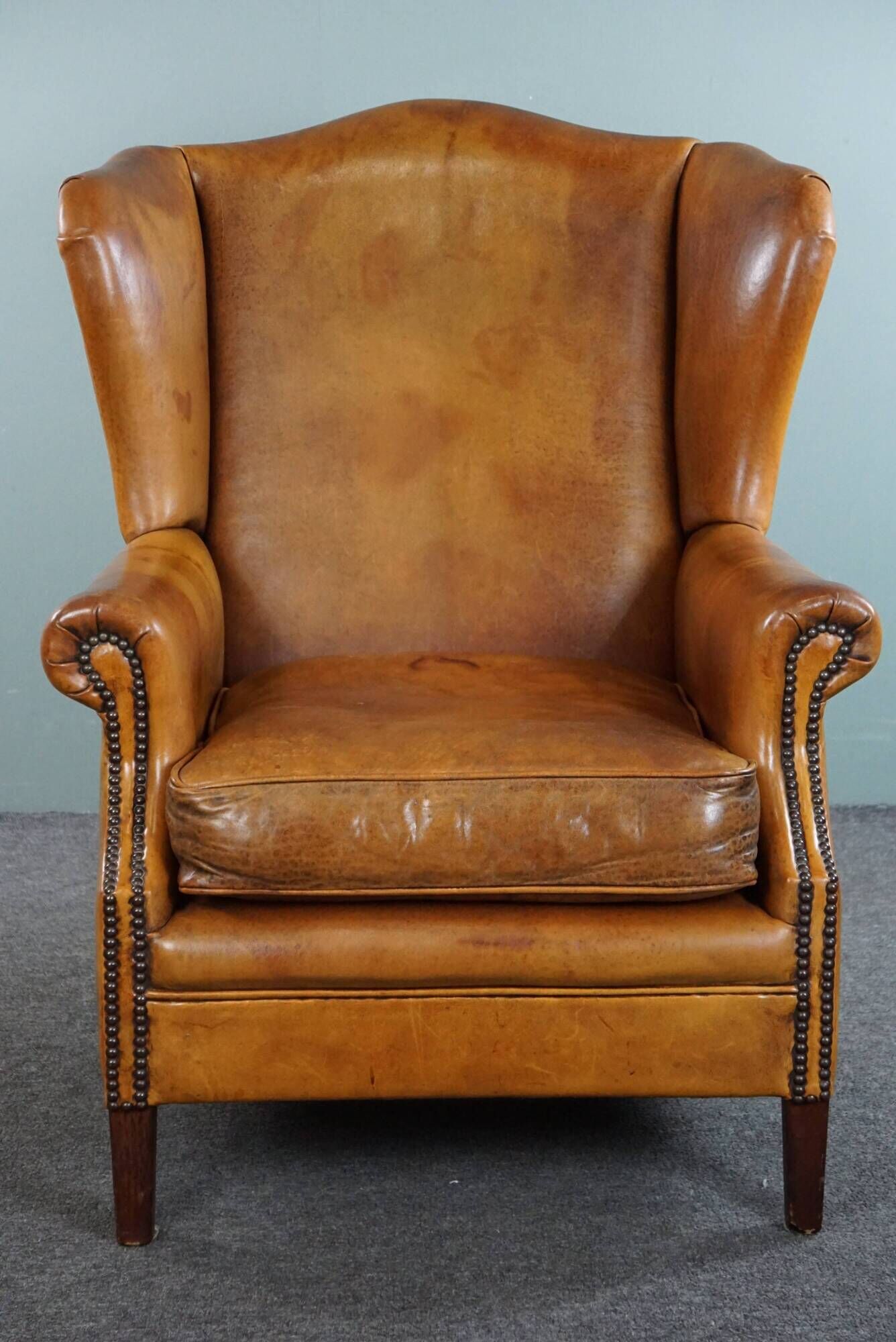 Wingback chair made of sheepskin leather in a light honey color