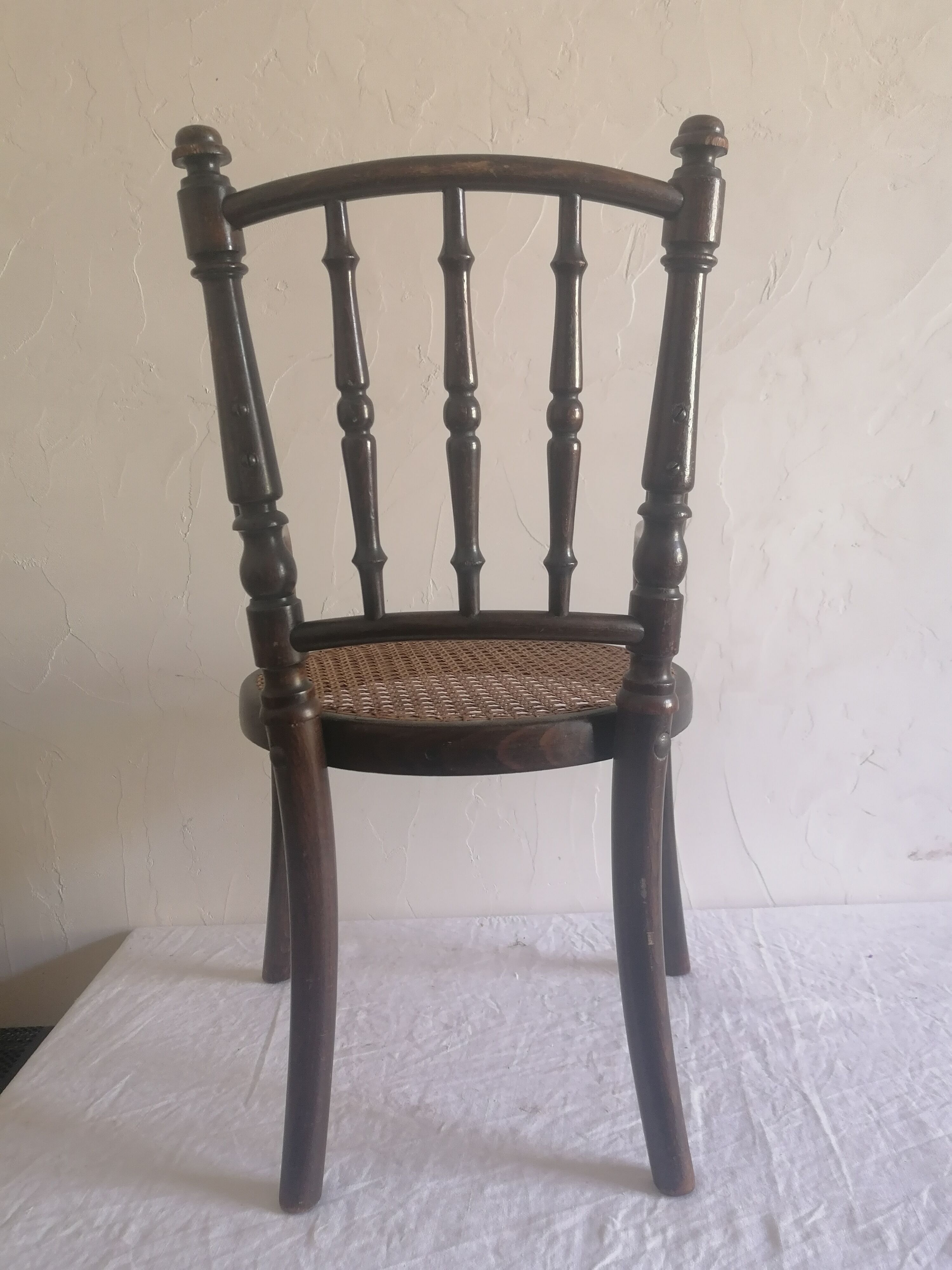 Old children's armchair in curved wood. Fischel