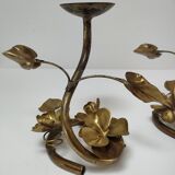Pair of brass candle holders decorated with patinated metal flowers