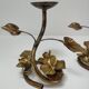 Pair of brass candle holders decorated with patinated metal flowers