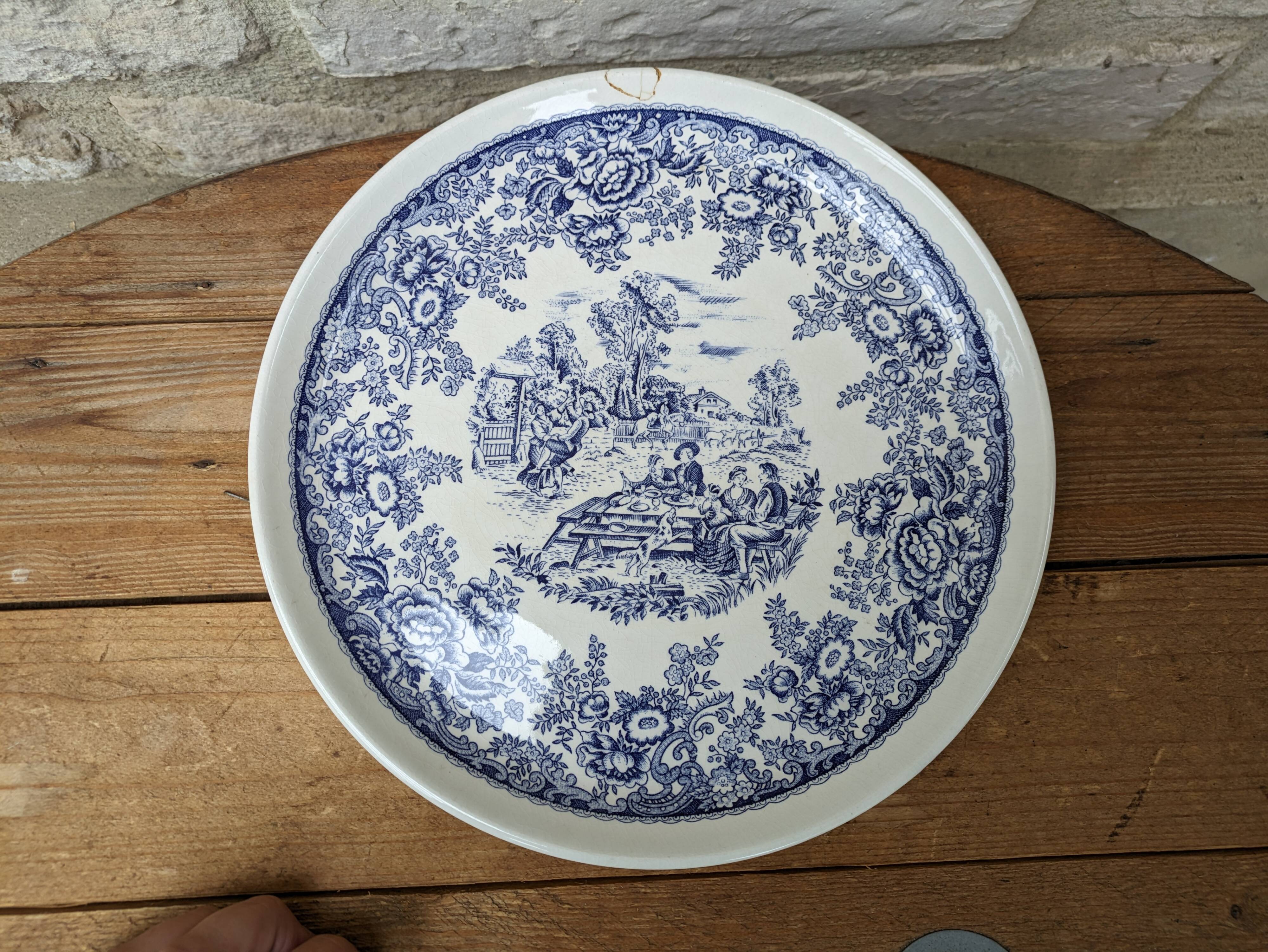 Old ceramic plate with scene of life and blue floral decor Van Melle