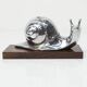 Silver snail candlestick on a teak base 1960