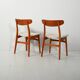 Pair of vintage teak chairs with a curved backrest