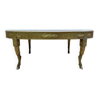 Oval coffee table with deer legs and marble in Empire style.